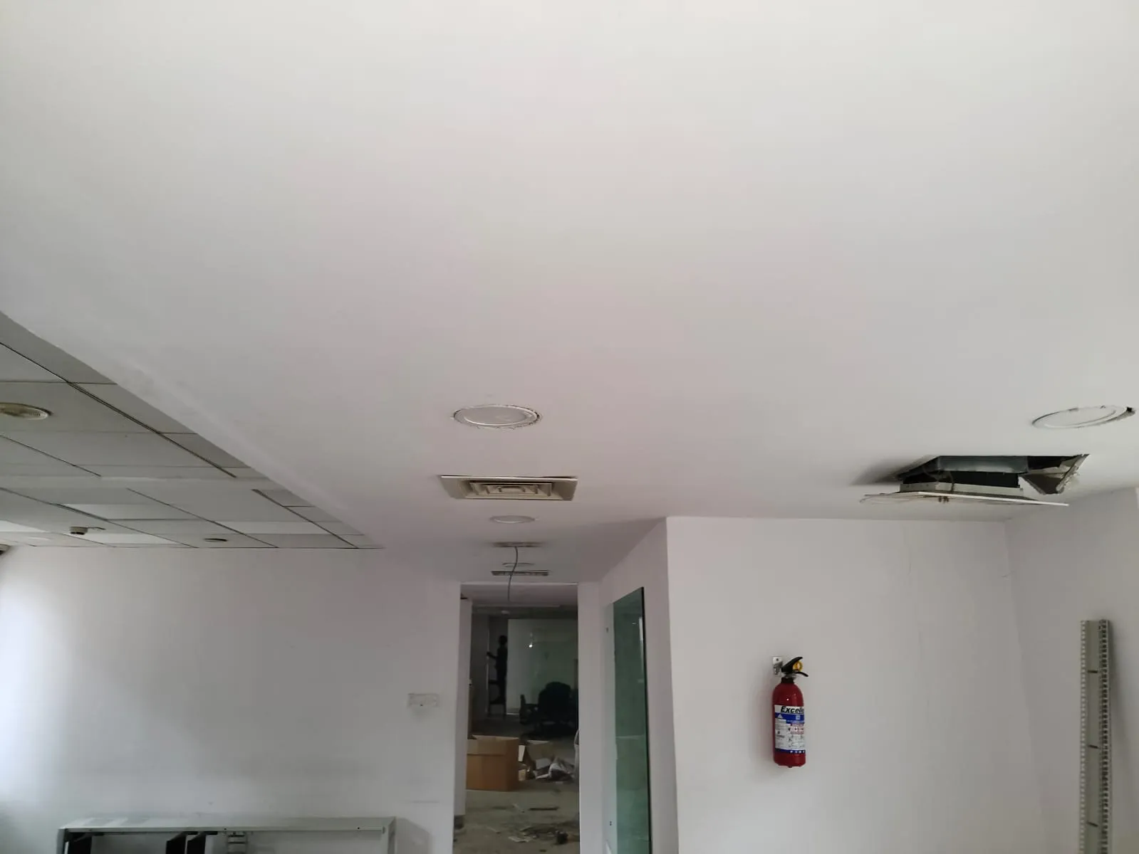An cleared corporate office space showing false ceilings, open corridors, and dismantled infrastructure during a corporate relocation service in Whitefield, Bengaluru
